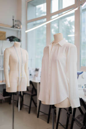 White handmade sewing shirt on dummy at studio sew workshop. Fashion dressmaker or seamstressの写真素材