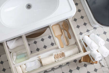 Marie Kondos method organization of bathroom amenities. Tidying up or storage household space