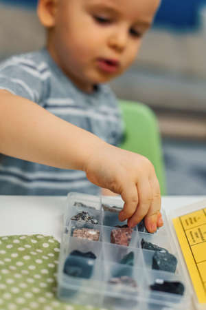 Children look at various samples of minerals. Home development and activities.
