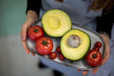 Top view of woman hands neatly organizing bathroom amenities and toiletries in drawer in bathroom.の写真素材