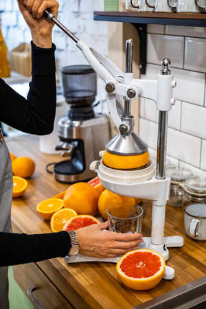 Happy domestic woman applying anti aging cream from jar on face looking at mirror in bathroomの写真素材