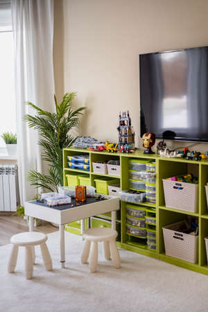 Khabarovsk, Russia, February 18, 2022. Childrens room sorting Lego models plastic box at cupboardのeditorial素材