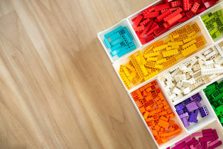 Khabarovsk, Russia, February 25, 2022. Many Lego Classic details sorting at boxes wooden copyspace