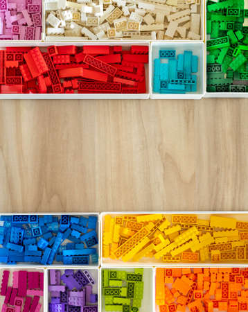 Khabarovsk, Russia, February 25, 2022. Many Lego Classic details sorting at boxes wooden copyspace