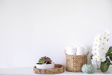 Potted plants in ecology straw baskets on shelf of bed linens cupboard textile arrangement storageの写真素材