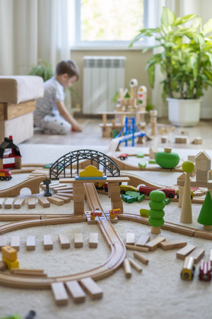 Preschool baby boy playing wooden Montessori materials rainbow arch railways at childish roomの写真素材