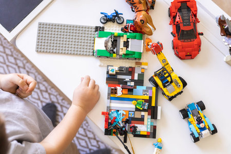 Khabarovsk, Russia, August 26, 2022. Boy constructing toy cars and use Lego Classic