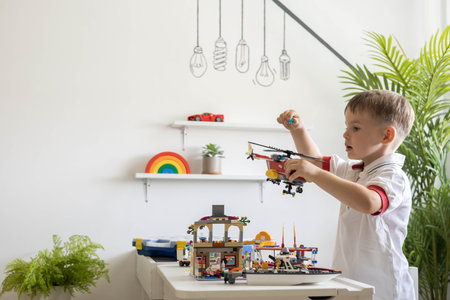 Khabarovsk, Russia, August 02, 2022. Male kid constructing toy helicopter and use Lego Classicのeditorial素材