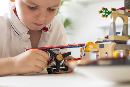 Khabarovsk, Russia, August 02, 2022. Male kid constructing toy airplane and use Lego Classicのeditorial素材