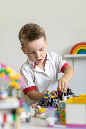 Khabarovsk, Russia, August 02, 2022. Male kid constructing toy cars and planes use Lego Classicのeditorial素材