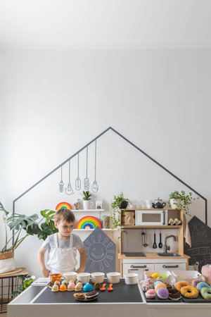 Male kid childish kitchen staff playing public catering service cafe counter ice cream toy imitationの写真素材