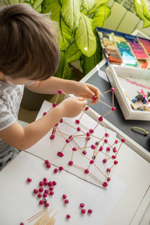 Confident cute baby boy playing and sculpt ball and toothpick design from plasticine fine motor skills early developmentの写真素材