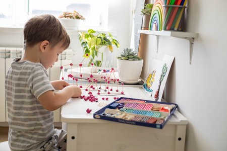 Confident cute baby boy playing and sculpt ball and toothpick design from plasticine fine motor skills early developmentの写真素材