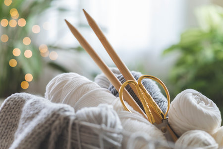 Cozy homely atmosphere. Female hobby knitting. Yarn in neutral colors in a white iron wire basket.