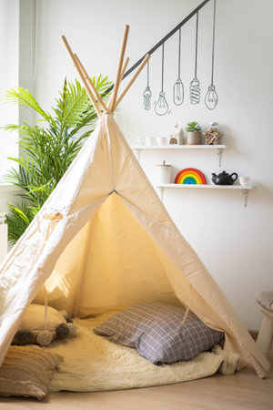 Childrens wigwam tepee from natural not dyed linen at childish Montessori materials room interiorの写真素材