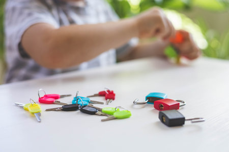 The child works with Montessori material with colored locks. Picks up keys. Develops fine motor skills.の写真素材