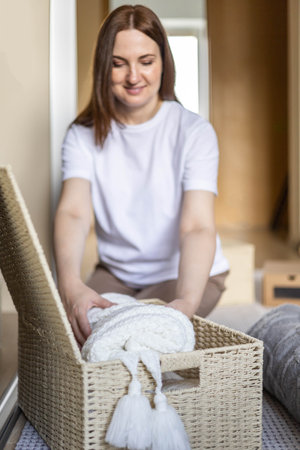 An unknown neat housewife lays out her underwear in the drawers of the wardrobe. The concept of organizing space and storing clothes.の写真素材
