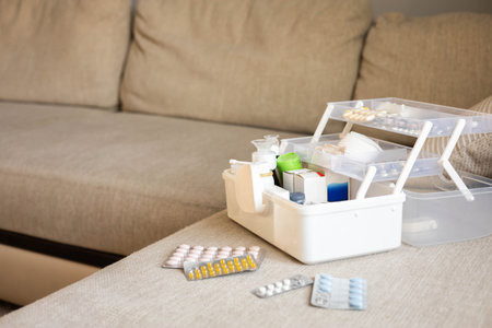 Closeup female hand placing medicament domestic first aid kit. Storage organization emergency supplyの写真素材