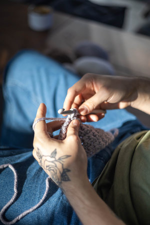 Modern hipster man crochet handmade hobby use hook knitting needles and wool yarn top view closeupの写真素材