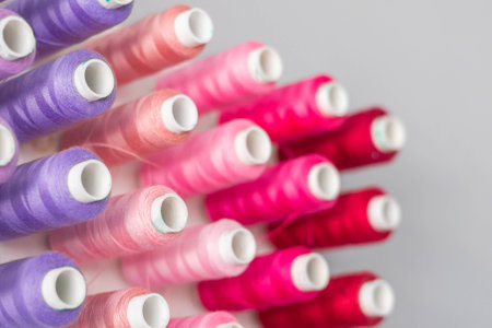 Multi-colored threads in spools and bobbins for sewing in a sewing workshopの写真素材