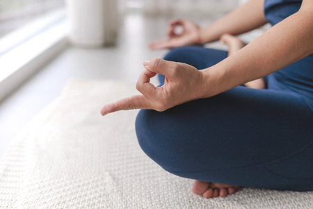 Unrecognizable yoga woman meditation in lotus position with mudra gyan gyana jnana hands closeupの写真素材