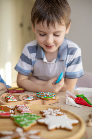 Merry Christmas and Happy Holidays. Boy cooking Christmas gingerman cookies.の写真素材