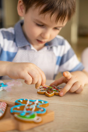 Merry Christmas and Happy Holidays. Boy cooking Christmas gingerman cookies.の写真素材