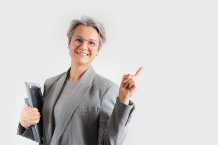 A middle-aged European woman with gray hair is wearing a formal gray jacket and glasses.の写真素材