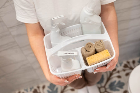 Portrait woman housewife plastic container bathroom chemical cleaner detergent storage organizing