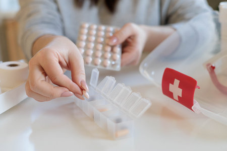 A woman takes her daily sedative or medicine for a headache or stomach pain.の写真素材