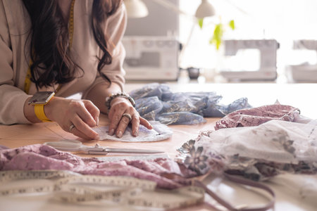 A woman seamstress designs and draws a pattern for underwear on graph paper.の写真素材