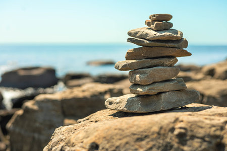 Stone tower at sunny sea coast beach balance harmony zen. Natural pebbleの写真素材