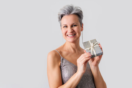 Smiling happy lady with gray hair and short haircut looking at cameraの写真素材