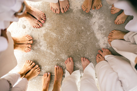 Group of barefoot people standing in circle on concrete surface, top view, friendship, unity conceptの写真素材