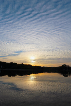 Beautiful evening sunset is reflected in the pondの写真素材