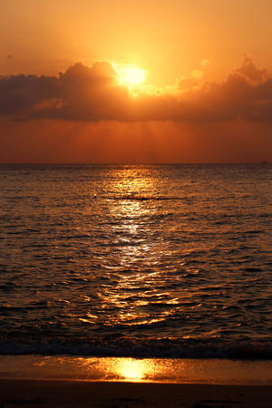 Sunset in the sea among the cloudsの写真素材