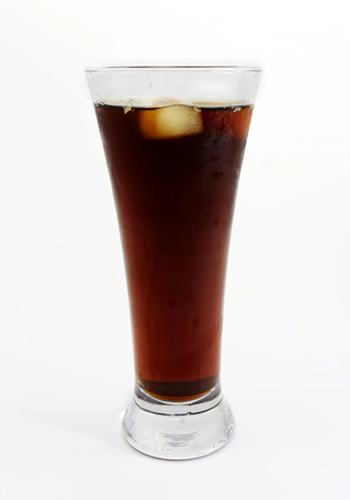 Glass with dark beer is photographed close-up on a white backgroundの写真素材