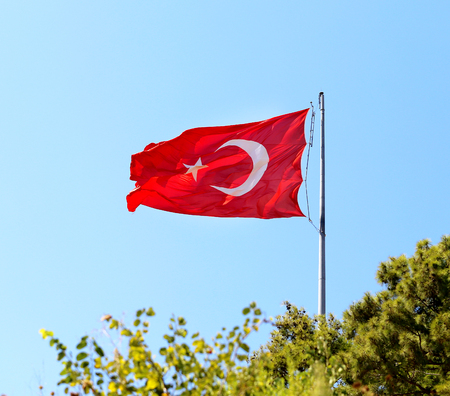 Beautiful red Turkish flag on a background blue skyの写真素材