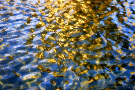 Beautiful Golden reflection on the water to photograph closeupの写真素材