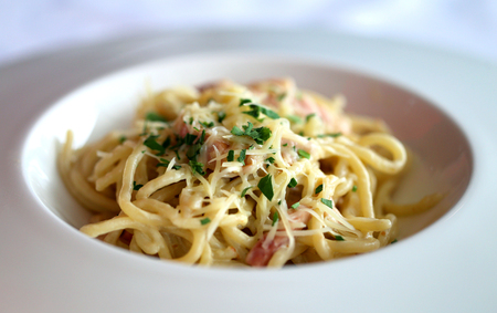 Delicious spaghetti pasta Carbonara in a white bowlの写真素材