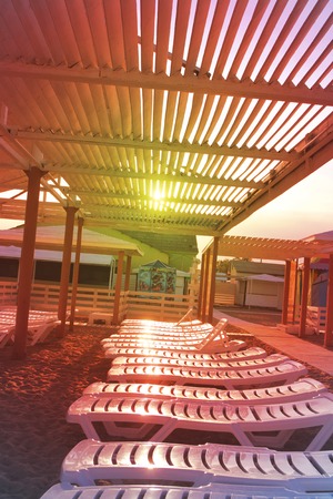 Beautiful sunbeds on the sandy beach of the Black sea, photographed in close-upの写真素材