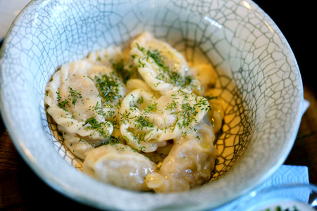 Delicious dumplings with cheese and onions in a bowlの写真素材