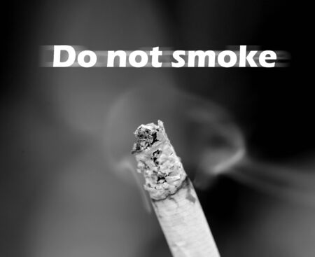 Cigarette with tobacco smoke photographed close upの写真素材