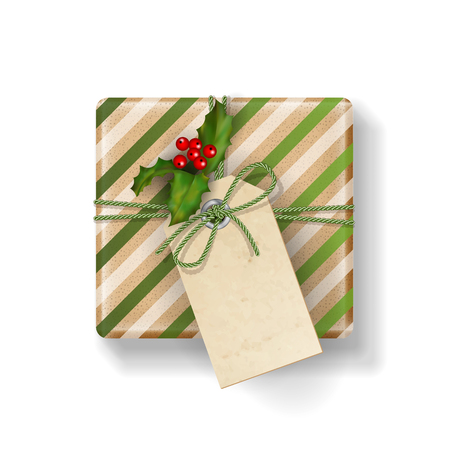 Wrapped vintage Christmas vector gift box with Holly branch, isolated on white. Top view on Xmas gift with blank labelのイラスト素材
