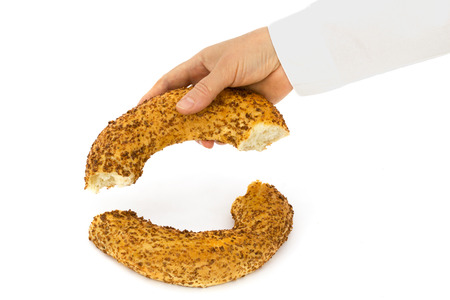 Baker holds a half from bagel, isolated on white background
