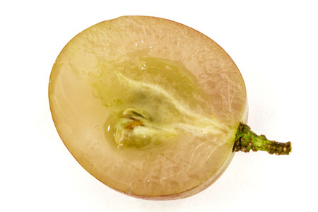 Half of the fruit of the grapes close-up, isolated on white backgroundの写真素材