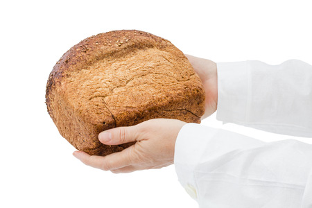 Baker holding fresh bread in the hands of, isolated on white background