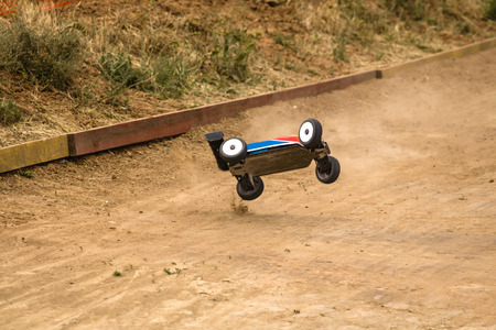 Radio controlled car model in race on dirt trackの写真素材
