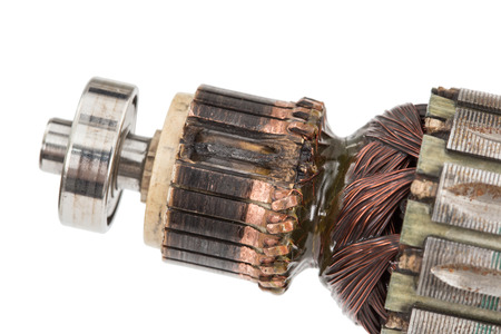 Damaged electric motor anchor, isolated on white backgroundの写真素材