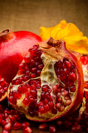 pumpkin and red pomegranate on wooden table  の写真素材